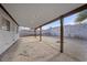 Spacious covered patio area in a large backyard featuring block wall for privacy at 1841 Golden Shadow Dr, Henderson, NV 89002