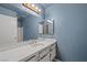 Bathroom features a blue wall with a vanity and a large mirror at 1841 Golden Shadow Dr, Henderson, NV 89002