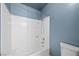 Bathroom with white shower/tub and blue accent wall at 1841 Golden Shadow Dr, Henderson, NV 89002
