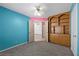 Colorful bedroom with carpet flooring, a ceiling fan, and a built-in wooden entertainment center at 1841 Golden Shadow Dr, Henderson, NV 89002