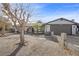 Charming single-story home featuring an attached two-car garage and unique desert landscaping at 1841 Golden Shadow Dr, Henderson, NV 89002