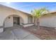 Inviting front entrance with an arched entryway, screen door, and well-kept landscaping at 1841 Golden Shadow Dr, Henderson, NV 89002