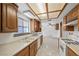 Bright kitchen features tile flooring, double sinks, and view to backyard at 1841 Golden Shadow Dr, Henderson, NV 89002