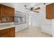 Bright kitchen featuring tile flooring, ceiling fan, and view to backyard at 1841 Golden Shadow Dr, Henderson, NV 89002