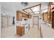 Cozy kitchen featuring wood cabinets, modern appliances, and tiled flooring at 1841 Golden Shadow Dr, Henderson, NV 89002