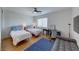 Bright bedroom featuring twin beds, modern ceiling fan, and wooden floors at 19 Desert Highlands Dr, Henderson, NV 89052