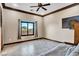 Neutral bedroom featuring tile flooring, recessed lighting, and natural light from a large window at 2051 Saginaw Ave, Pahrump, NV 89048