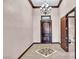 Inviting home foyer with a rustic wooden front door, tiled floor and decorative chandelier at 2051 Saginaw Ave, Pahrump, NV 89048