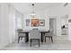 Bright dining area with a modern light fixture, art-adorned walls, and a neutral color palette at 2230 Spring Water Dr, Las Vegas, NV 89134