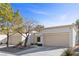 Exterior view of the house showing two garages and desert-style landscaping at 2230 Spring Water Dr, Las Vegas, NV 89134