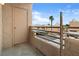 Balcony view featuring stucco wall, metal railing, storage closet, and desert landscape at 2232 Aspen Mirror Way # 202, Laughlin, NV 89029