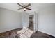 Empty bedroom with wood floors, a ceiling fan, and an open doorway to another room at 2414 Inlet Beach Ct, North Las Vegas, NV 89031