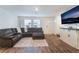 Bright living room with a comfortable sectional, laminate flooring, and lots of natural light at 332 Pacific Sparrow Ave, Henderson, NV 89011