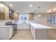 Spacious kitchen featuring updated stainless steel appliances and quartz countertops at 336 Merit Ct, Henderson, NV 89014