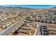 Wide aerial view of a residential community nestled against a backdrop of distant mountains under a clear blue sky at 3491 Argiento Ave, Henderson, NV 89044