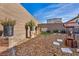 Well-kept backyard with a decorative wishing well, potted plants, and a relaxing seating area at 3491 Argiento Ave, Henderson, NV 89044