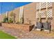 Backyard area with a brick-paved path, garden bed, and privacy wall, ideal for relaxation at 3491 Argiento Ave, Henderson, NV 89044