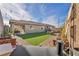 Large backyard featuring artificial grass, paved area, and outdoor seating, perfect for entertaining at 3491 Argiento Ave, Henderson, NV 89044