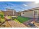 Landscaped backyard featuring manicured lawn, brick borders, and patio furniture for outdoor living at 3491 Argiento Ave, Henderson, NV 89044