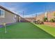 Landscaped backyard featuring manicured lawn, brick borders, and patio furniture for outdoor entertaining at 3491 Argiento Ave, Henderson, NV 89044