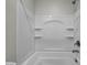 Bright and clean bathtub-shower combo with built-in shelving at 3491 Argiento Ave, Henderson, NV 89044