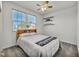 Bright bedroom featuring a comfortable queen-size bed, two windows, and minimalist decor at 3491 Argiento Ave, Henderson, NV 89044