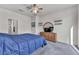 The bedroom features neutral walls, a ceiling fan, carpet, and round mirror over the dresser at 3491 Argiento Ave, Henderson, NV 89044