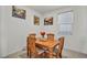 Inviting dining room features a wooden table with seating for four, natural lighting, and neutral decor for comfortable meals at 3491 Argiento Ave, Henderson, NV 89044
