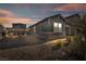 Charming single-story home featuring stone accents and a well-maintained yard with decorative string lights at 3491 Argiento Ave, Henderson, NV 89044