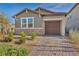 Charming single-story home featuring stone accents, desert landscaping, and a paved driveway at 3491 Argiento Ave, Henderson, NV 89044