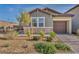 Charming single-story home with a two car garage, stone accents, and desert landscaping at 3491 Argiento Ave, Henderson, NV 89044