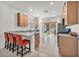 Bright kitchen features granite countertops, breakfast bar with seating, stainless steel appliances, and tile flooring at 3491 Argiento Ave, Henderson, NV 89044