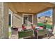 Relaxing covered patio with comfortable outdoor furniture, perfect for enjoying the backyard at 3491 Argiento Ave, Henderson, NV 89044