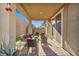 Charming covered patio with outdoor seating and scenic views of the landscaped backyard at 3491 Argiento Ave, Henderson, NV 89044