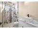 Modern bathroom with a walk-in shower with gorgeous marble tiling and a stylish white vessel sink at 3520 Malibou Ave, Pahrump, NV 89048