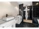 Elegant bathroom has dual vessel sinks, and a tiled shower with black fixtures at 3520 Malibou Ave, Pahrump, NV 89048