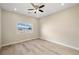 Comfortable bedroom features a neutral color palette and a window view of the mountain range at 3520 Malibou Ave, Pahrump, NV 89048