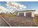 Paver driveway leading to a charming single-story home featuring desert landscaping and a three-car garage at 3520 Malibou Ave, Pahrump, NV 89048