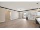 Spacious great room with a dining area and modern kitchen with marble countertops and sleek white cabinetry at 3520 Malibou Ave, Pahrump, NV 89048