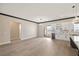 Spacious great room with a dining area and modern kitchen with marble countertops and sleek white cabinetry at 3520 Malibou Ave, Pahrump, NV 89048