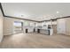 Open floor plan with a modern kitchen, dining area and an abundance of natural light from the sliding glass door at 3520 Malibou Ave, Pahrump, NV 89048
