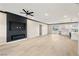 Open-concept living room features wood-look floors, a modern fireplace, and seamless access to the kitchen at 3520 Malibou Ave, Pahrump, NV 89048