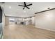 Bright open-concept living area with hardwood floors that flow into a modern kitchen with sleek white cabinets at 3520 Malibou Ave, Pahrump, NV 89048