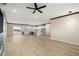 Bright open-concept living area with hardwood floors that flow into a modern kitchen with sleek white cabinets at 3520 Malibou Ave, Pahrump, NV 89048