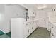 Well-lit kitchen showcasing crisp, white cabinets and modern fixtures, and tile floors at 3550 Bay Sands Dr # 1091, Laughlin, NV 89029