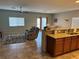 Open concept living room featuring tile floors, ceiling fan, large windows and open access to the kitchen at 4399 S Laurel Ln, Pahrump, NV 89061