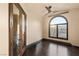Bedroom featuring dark wood floors, an arch window, and a ceiling fan at 5764 Aspen Falls Cir, Las Vegas, NV 89149