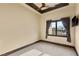 Bedroom featuring neutral colors, ceiling fan, carpet floors, and backyard views at 5764 Aspen Falls Cir, Las Vegas, NV 89149
