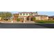 Exterior elevation of large home with driveway, three car garage and manicured landscaping at 5764 Aspen Falls Cir, Las Vegas, NV 89149