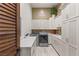 Spacious laundry room with sink, storage cabinets, and stainless steel washer and dryer at 5764 Aspen Falls Cir, Las Vegas, NV 89149